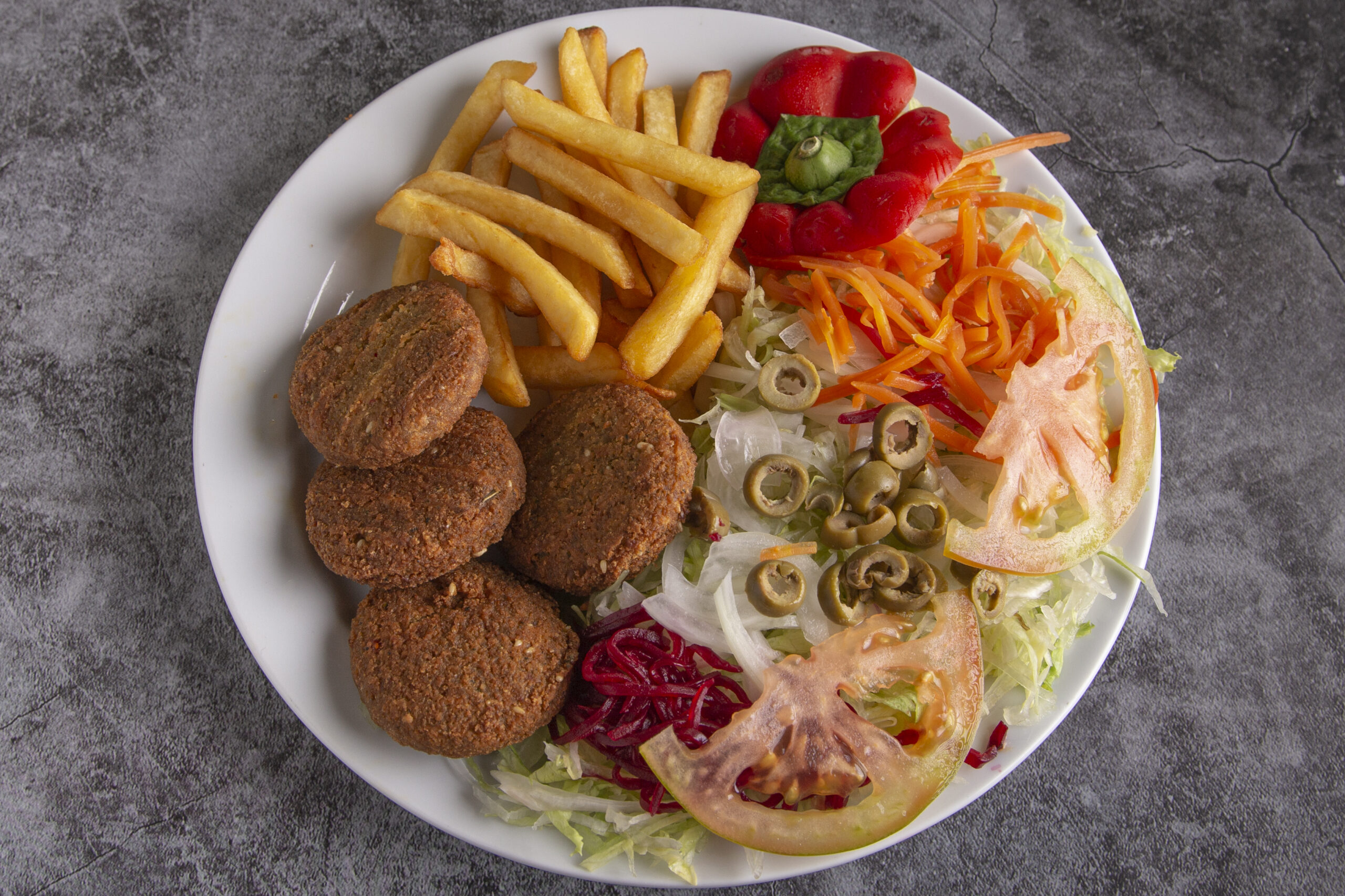 Falafel platter with salad and fries served at a fast food outlet